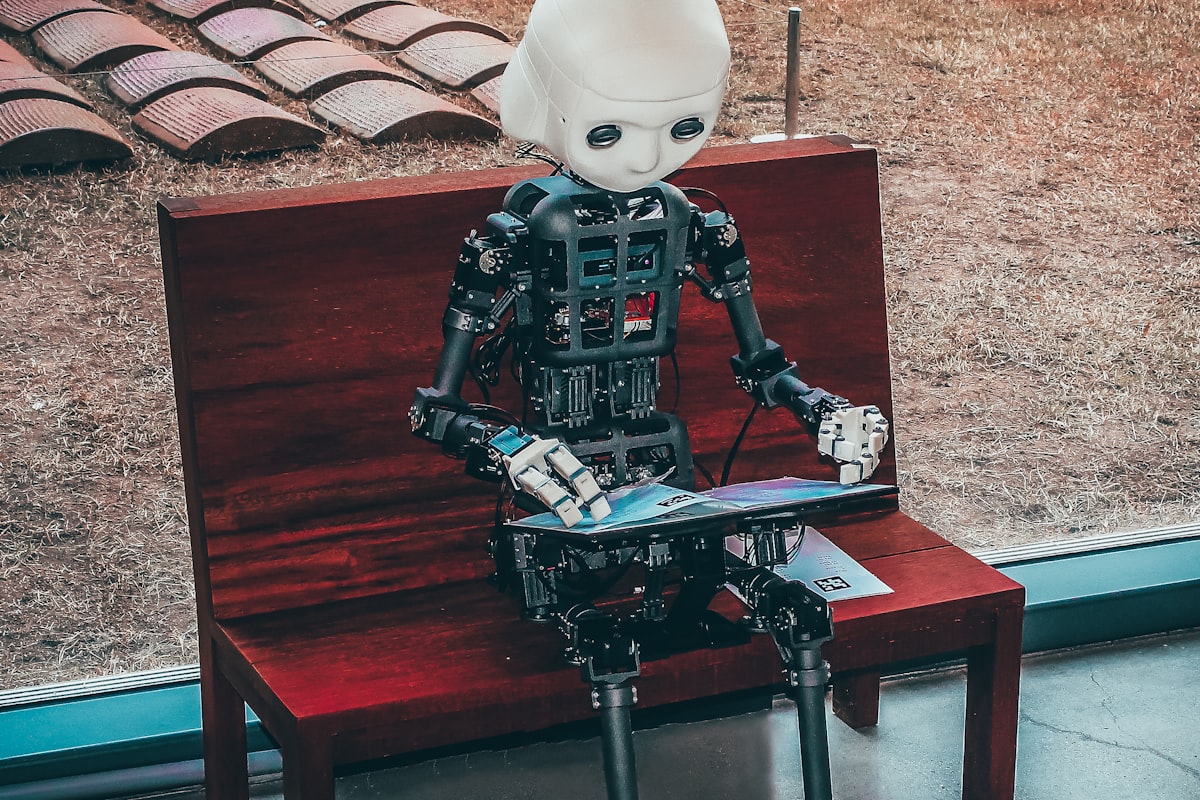 A robot using a laptop, representing agentic search doing the work for users