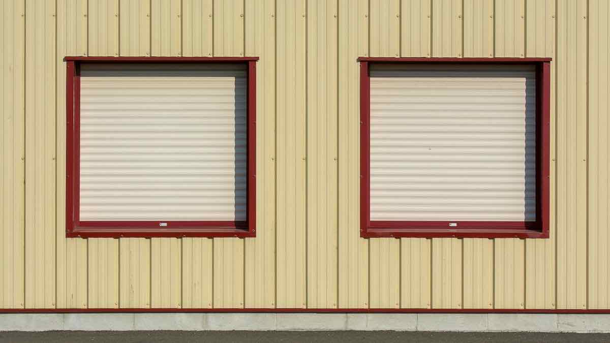 A single open door in a long wall of closed shutters, a metaphor for the narrow route left into Reddit data