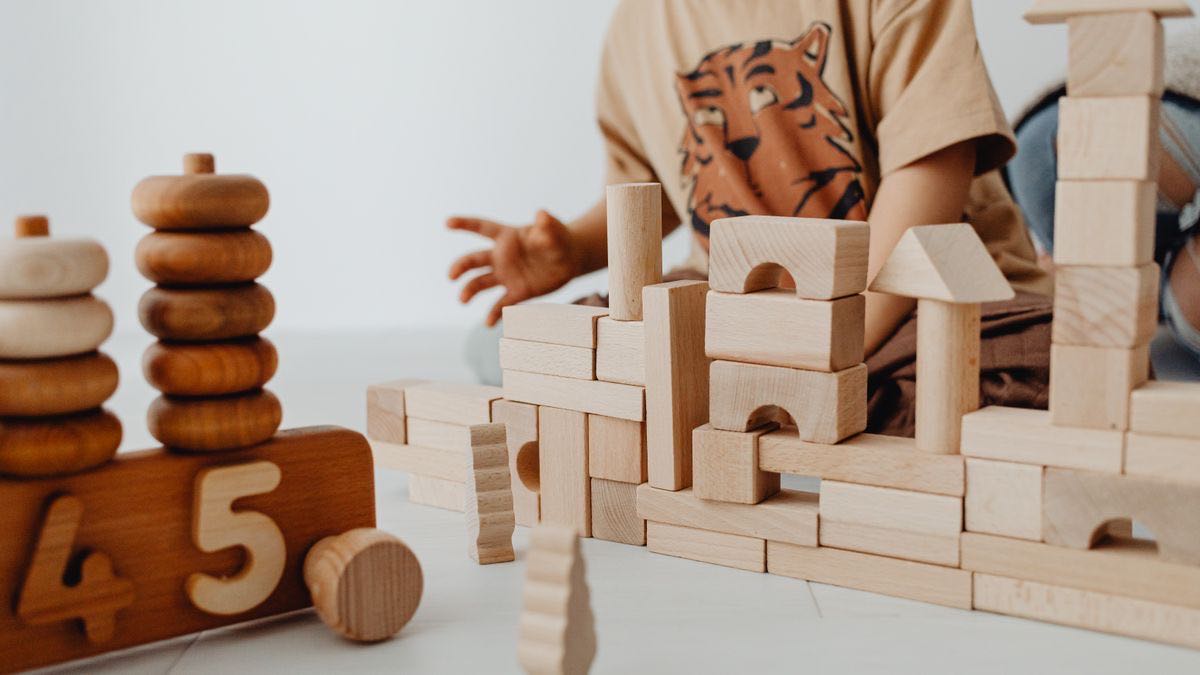 Wooden building blocks being assembled into a structure — a metaphor for assembling a job board from a data feed