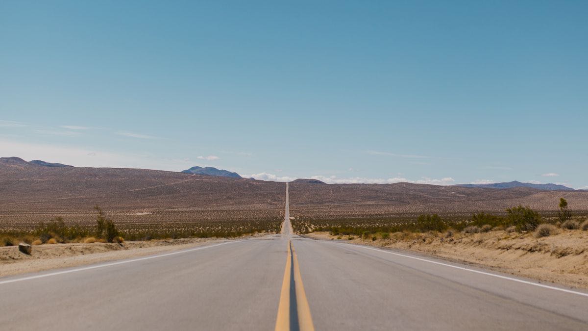 A perfectly straight desert highway stretching to the horizon, representing the simpler integration path