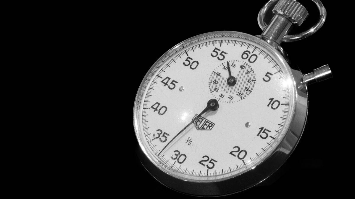 A vintage mechanical stopwatch on a black background, a metaphor for benchmarking the fastest Python HTML parser