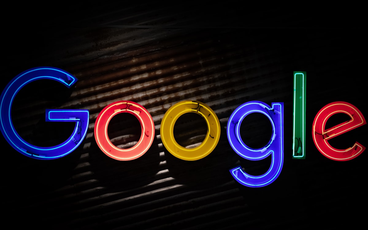 Colourful neon Google logo on a dark wall, representing the end of the Google Custom Search JSON API