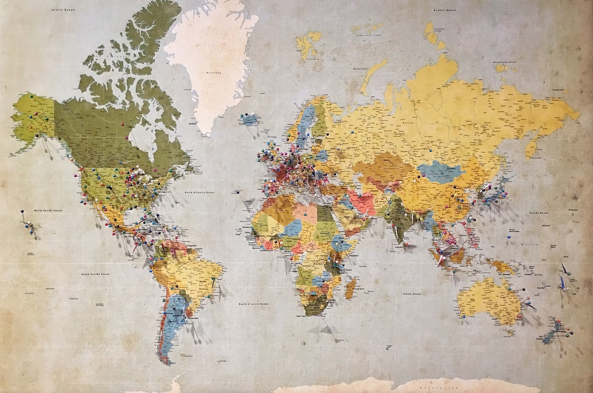 A world map covered in colored location pins, representing geo-grid local rank tracking points