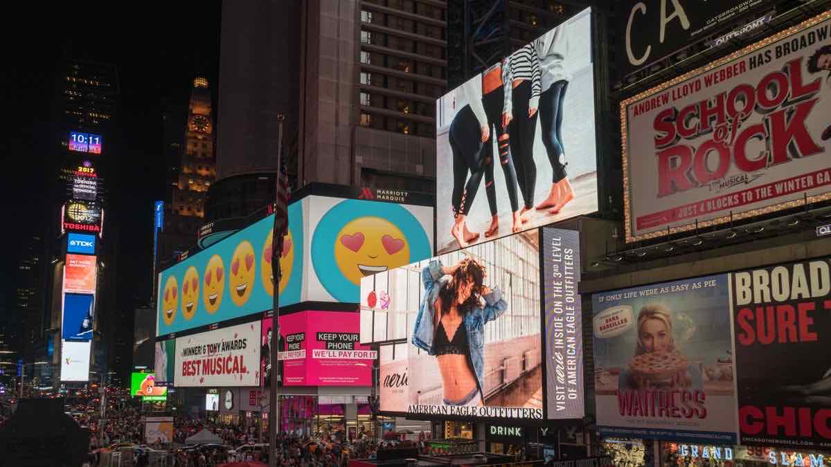 Outdoor billboards at a city intersection, symbolizing paid advertising placements that appear in product listings