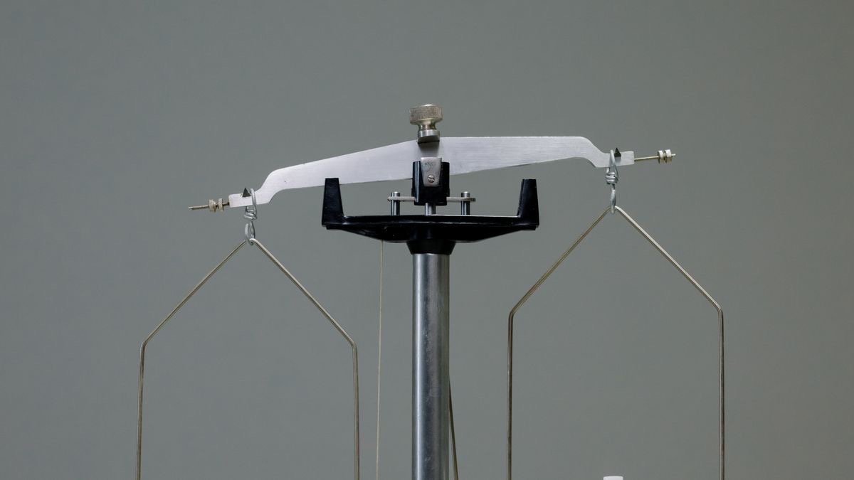 Two antique scales side by side, reinforcing the idea of weighing offers from two engines