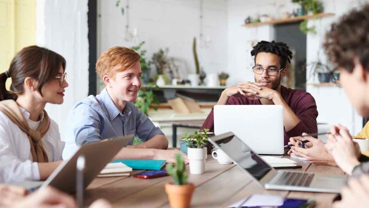 A diverse hiring team collaborating around a table — building a candidate sourcing pipeline from LinkedIn data