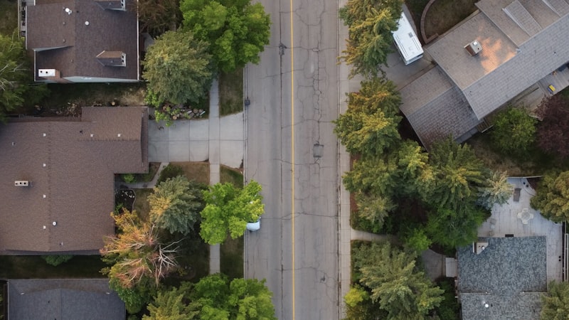 Aerial top-down view of a residential neighborhood street with houses and trees, representing hyperlocal map pack ranking territory