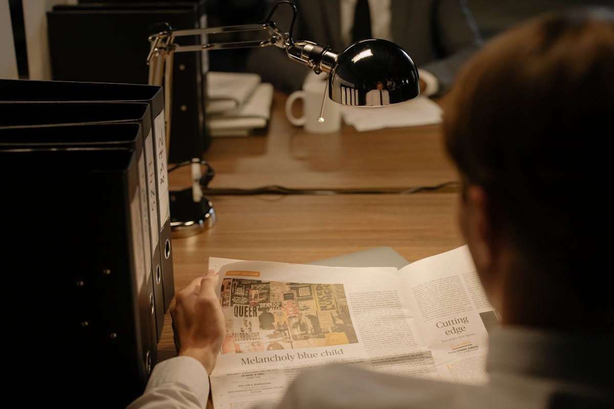 Person reading newspaper for news API concept