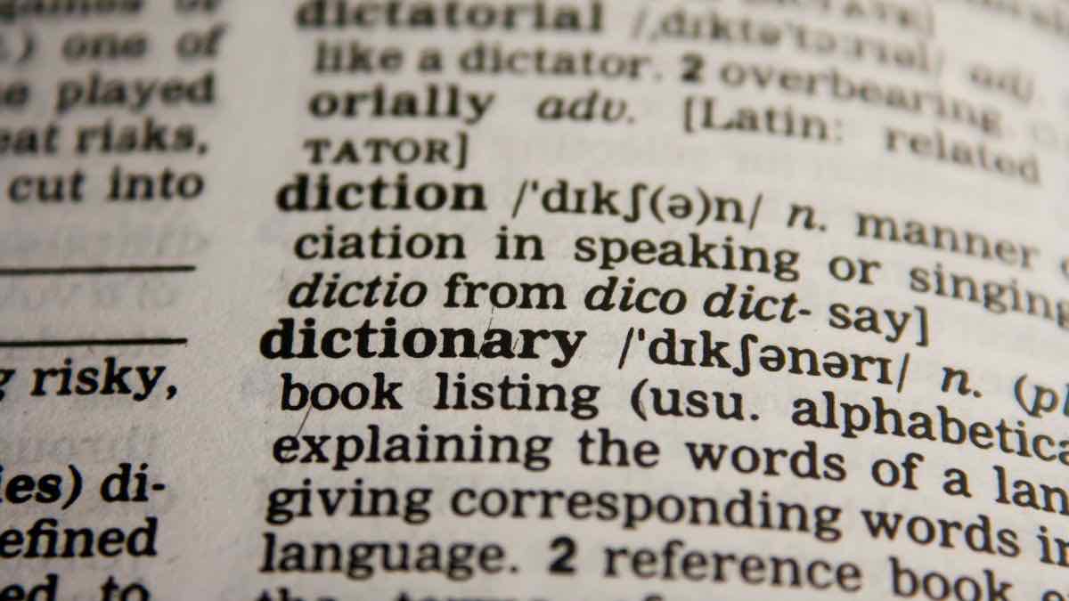 Dictionary page close-up showing the definition of the word dictionary