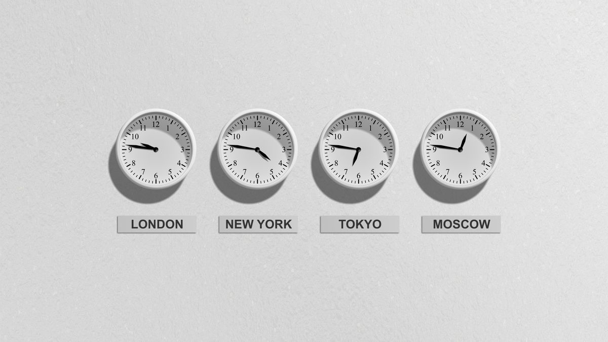 Four wall clocks labeled London, New York, Tokyo and Moscow showing different times — the same moment measured four different ways