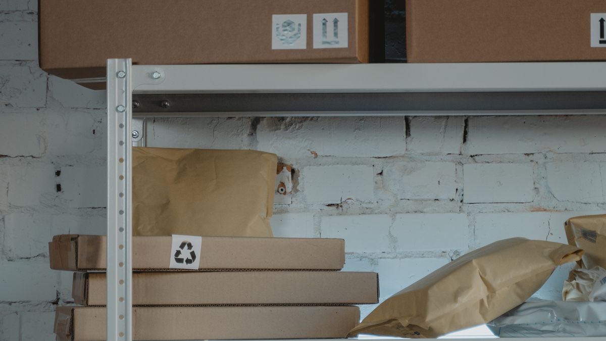 Rows of labelled archive boxes on metal shelving, illustrating that live Reddit APIs are not historical archives
