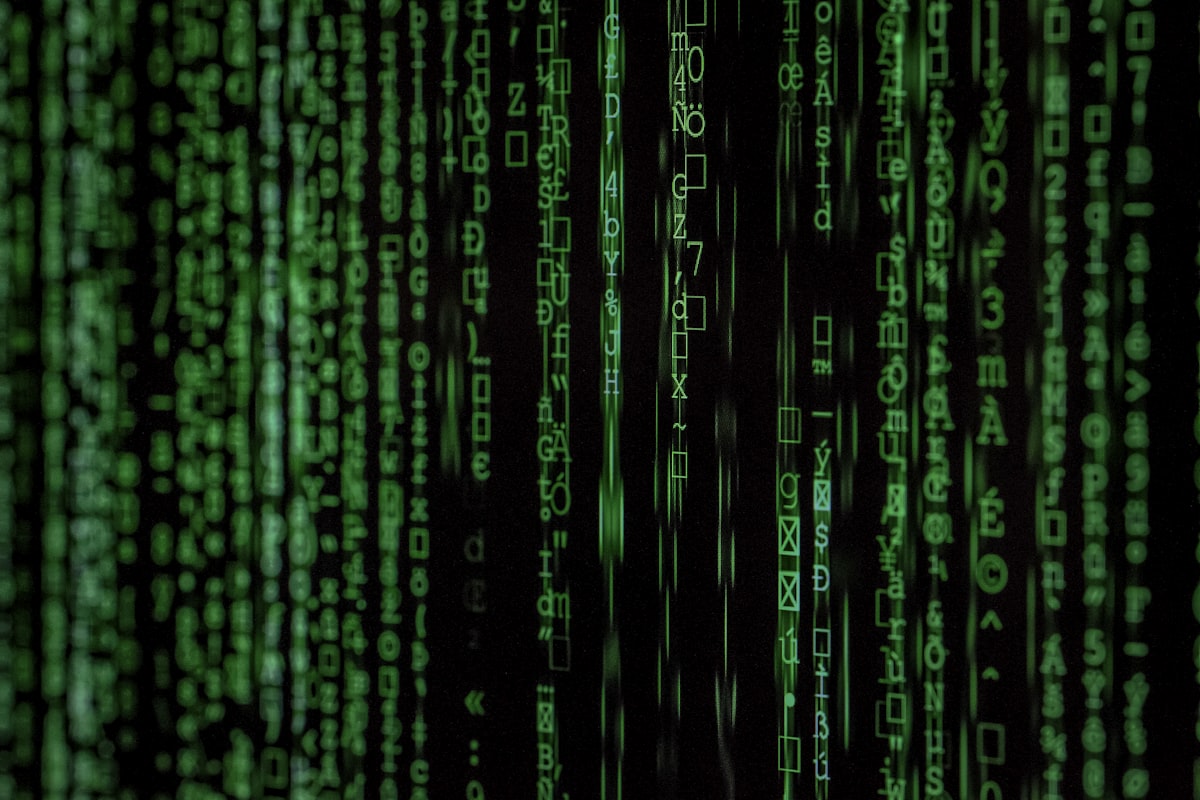 Streams of green code on a dark screen, representing AI engines parsing citation sources
