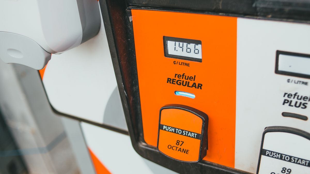 The advertised price per litre glowing on the display of a petrol pump before any fuel is drawn