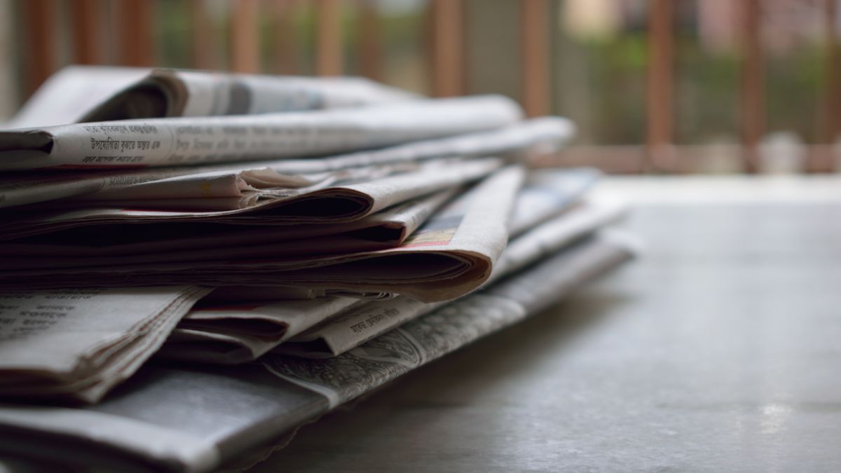 A stack of folded newspapers, representing scraping Google News headlines for free