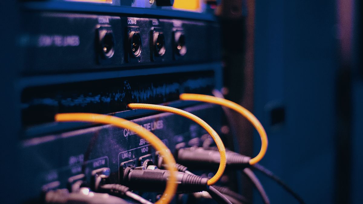 Cables routed into network ports, representing the Yahoo redirect tracker that wraps every result link