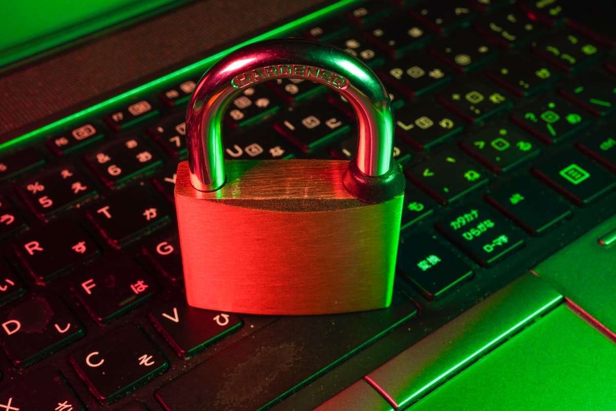 A padlock lit in red and green sitting on a laptop keyboard, representing a blocked Google scraper