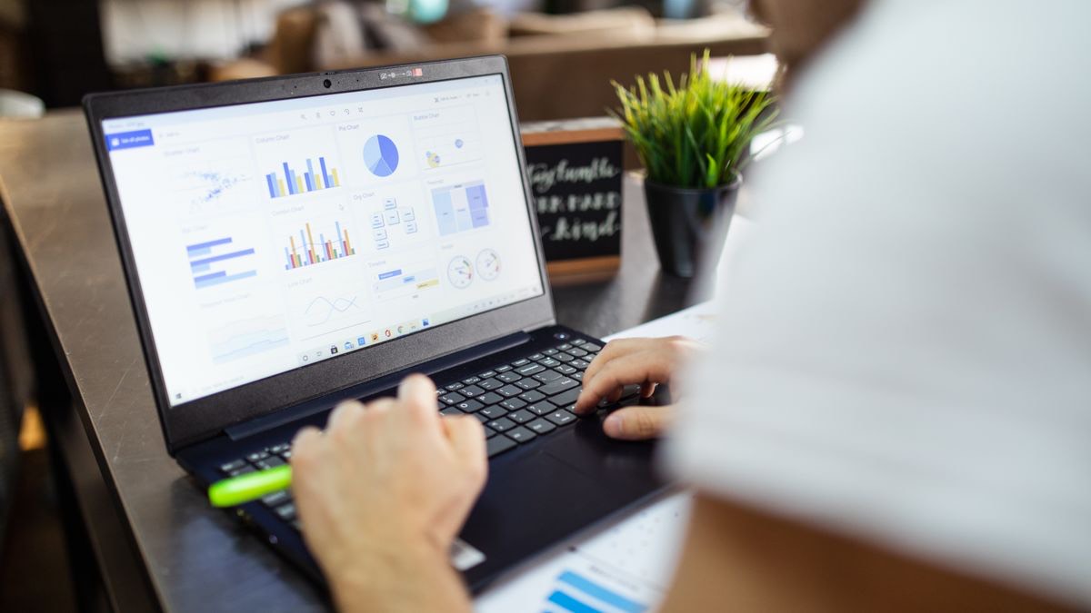 A developer reviewing an analytics dashboard on a laptop, representing tracking ScraperAPI credit usage and cost