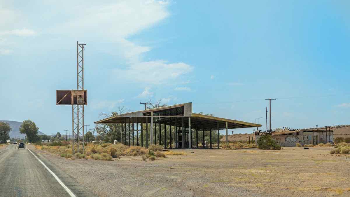 An abandoned desert gas station with an empty canopy and no working pumps, a metaphor for rank-tracker providers that no longer serve