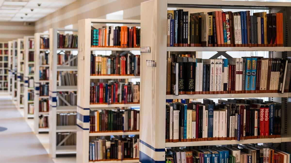 An open dictionary and a laptop, representing a glossary of SERP API and AI search terms