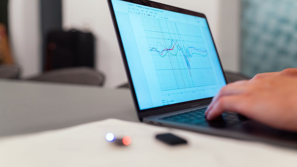 A laptop screen showing a line-graph ranking dashboard, representing a rank tracking API