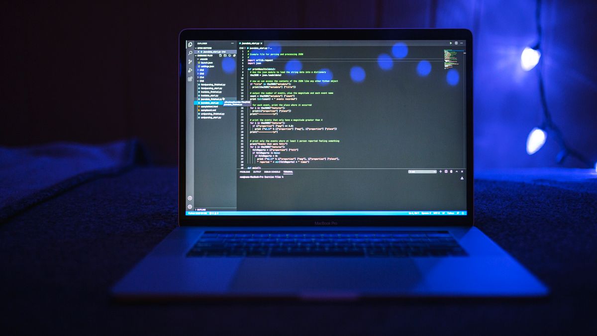 Code editor on a laptop showing a Python script that parses SERP API JSON results