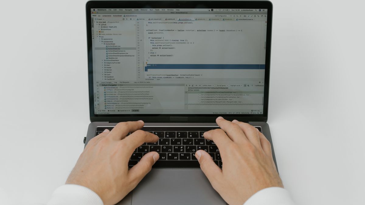 A hooded figure typing in the dark, representing stealth browser automation and the Runtime.enable CDP leak