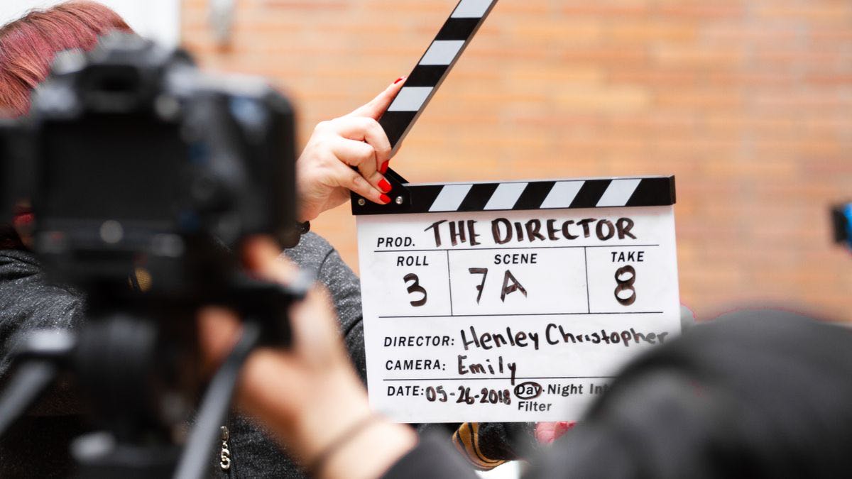 A film clapperboard being held up in front of a camera before a take