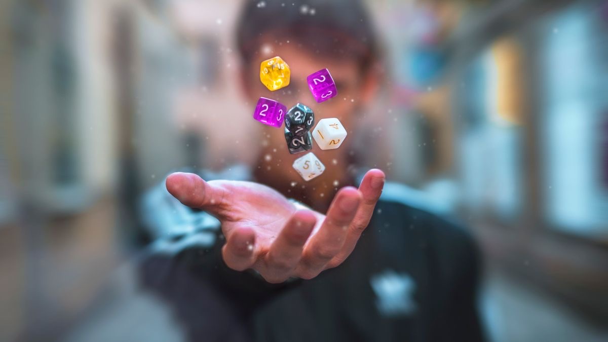 A hand tossing several colorful dice into the air, representing the randomness in Google search results