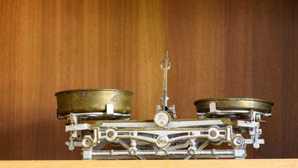 Weighing scales holding differently sized stones, a metaphor for comparing X API prices quoted in units that are not equal