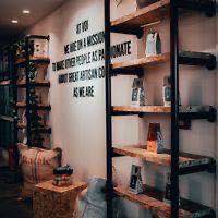 Retail shelves of bagged coffee in a roastery shopfront