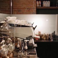 Espresso machine on a brick-walled coffee bar